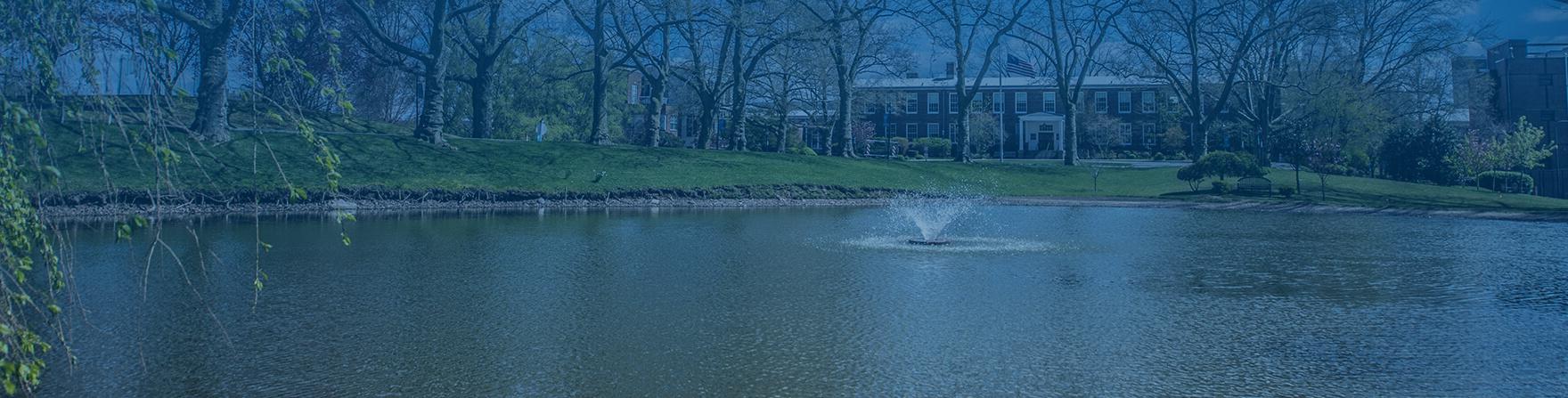 Poly Endowment header pond with school in background